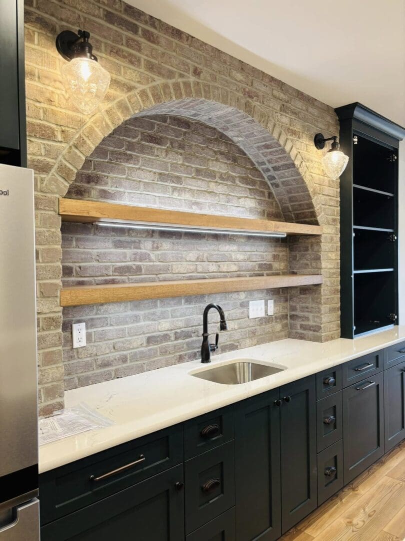 Modern kitchen backsplash with brick arch and floating wooden shelves.